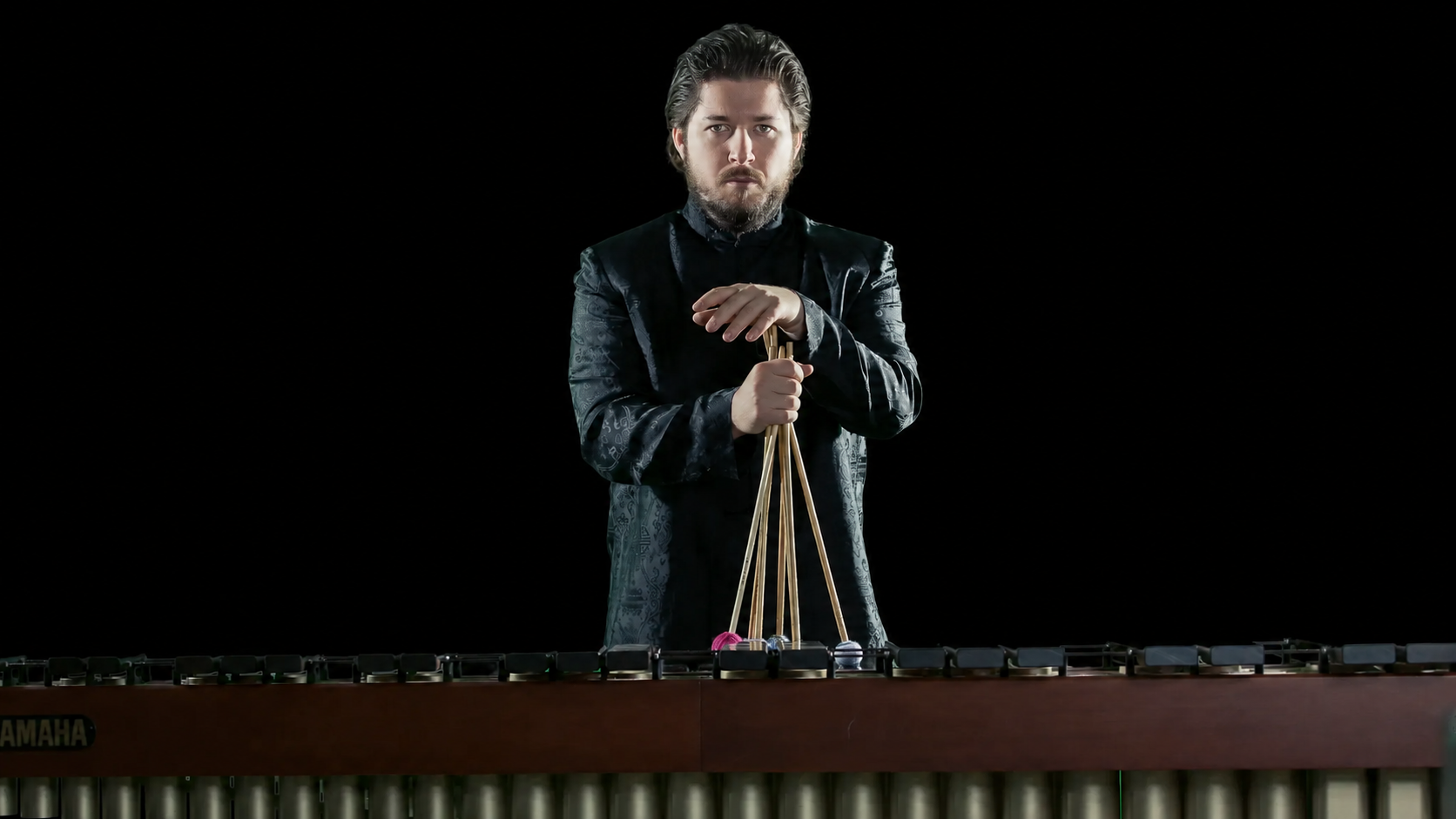 Theodor Milkov standing behind a marimba